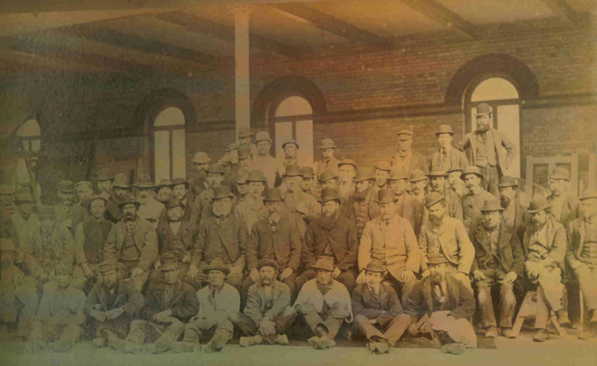 During this employment he worked on the Norwich Agricultural Hall and the photograph shows Edward with his colleagues from J Youngs and J W Lacey, taken in 1883.?(Edward is sitting far left)