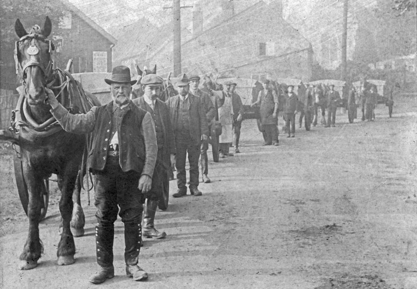 1905 Picture shows a line of Tumbrels made by Edward Thrower Taylor on the main road at Cringleford (Church in background and Edward's house in centre) Mr Girdlestone (Foreman), followed by Herbert then Edward Taylor